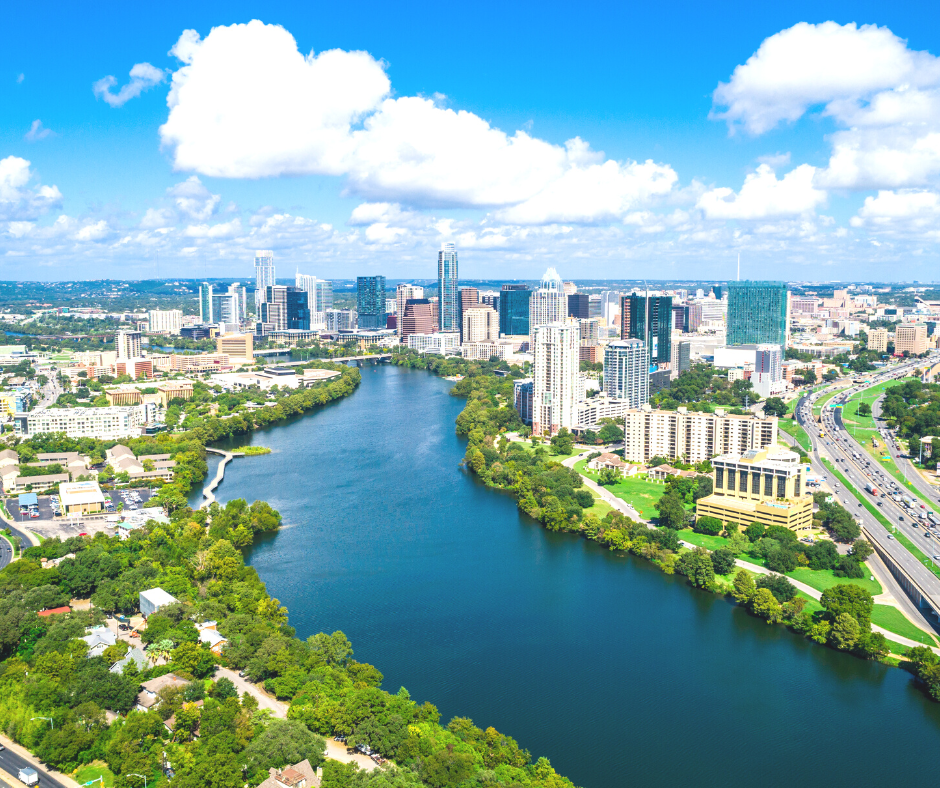 daytime skyline view of Austin Texas along the river. 